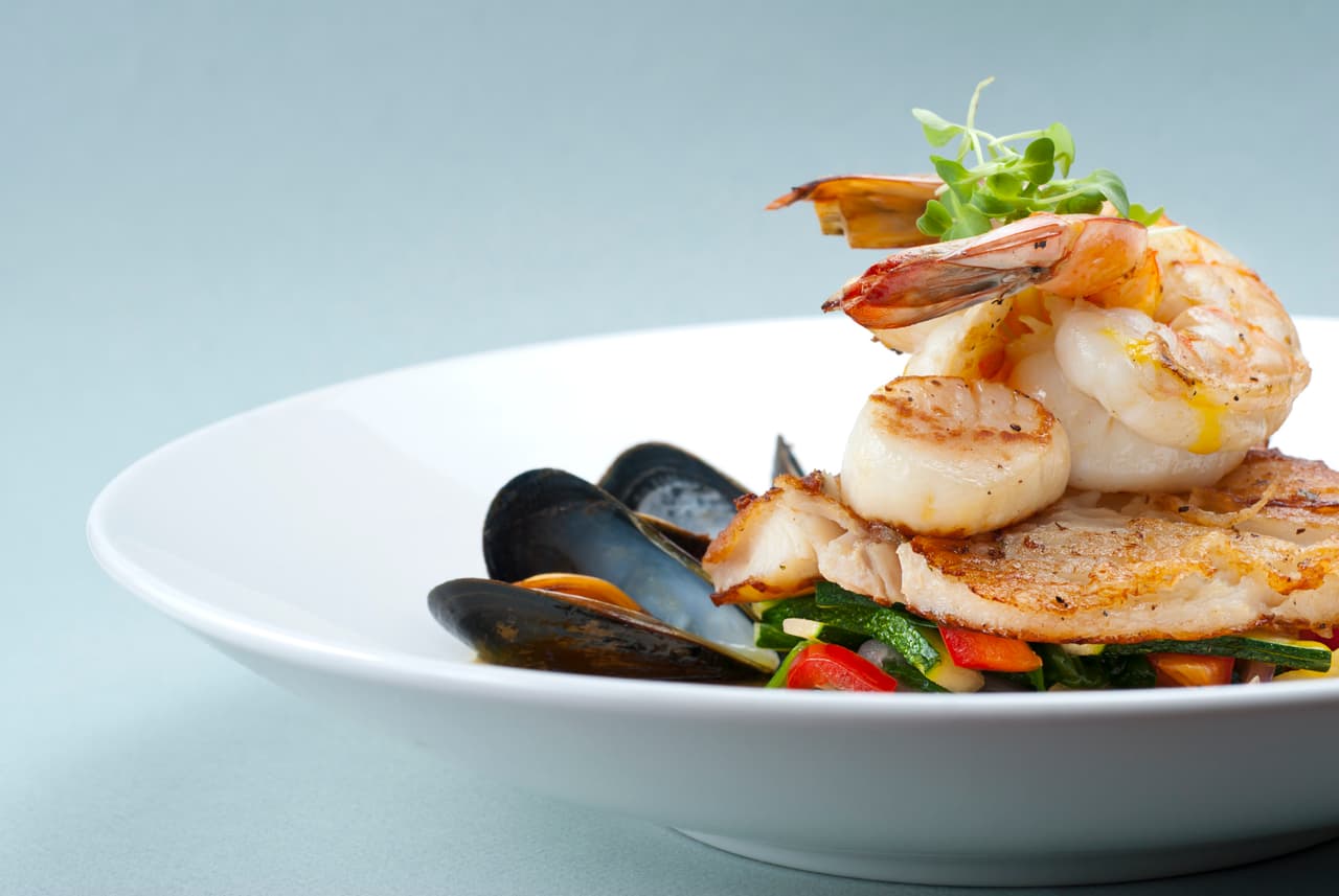 Seafood medley of shrimp, scallops, mussels and fresh fish over a bed of vegetables.
