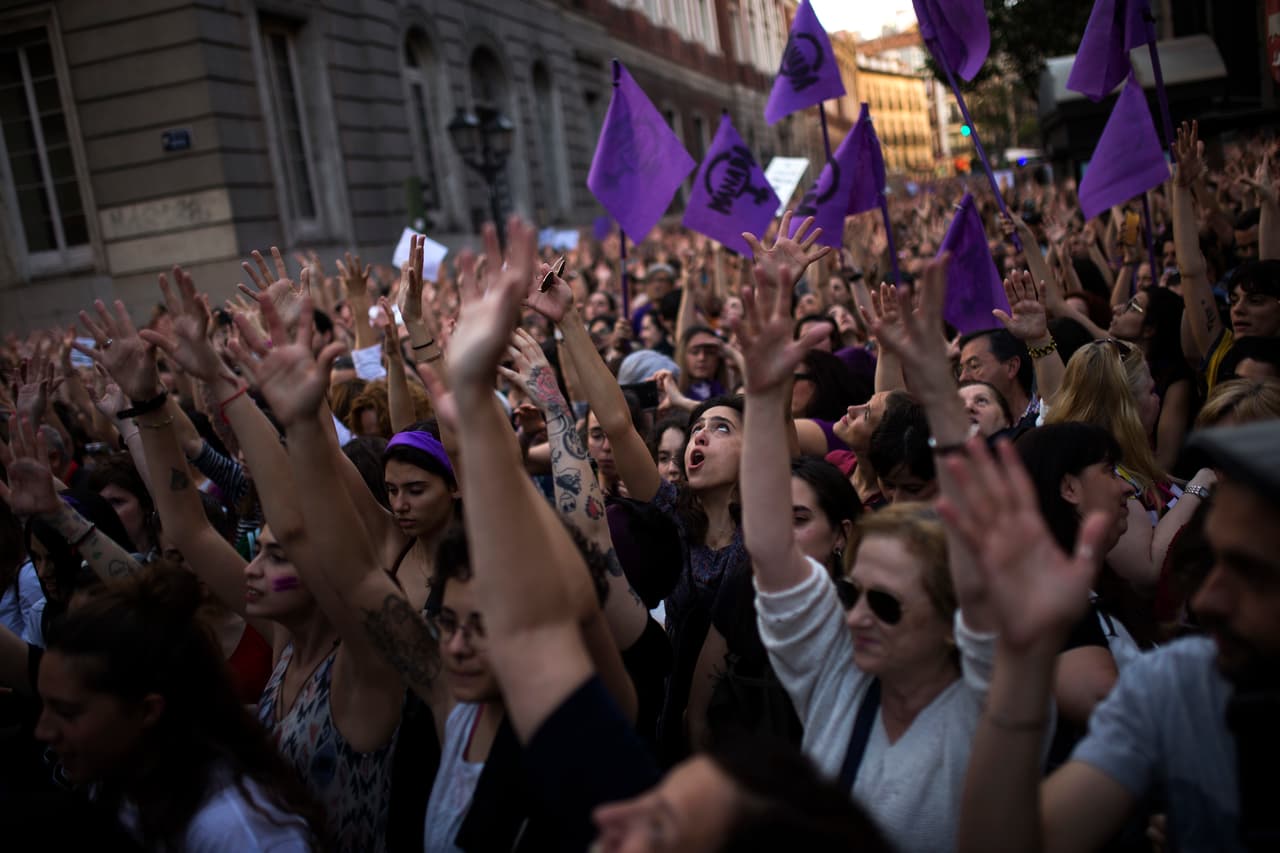 People lift up their arms as the shout slogans during a protest outside the Justice Ministry in Madrid, Thursday, April 26, 2018. Women's rights groups protested Thursday after a court in northern Spain sentenced five men to nine years each in prison for the lesser crime of sexual abuse in what activists saw as a gang rape during the 2016 running of the bulls festival in Pamplona. (AP Photo/Francisco Seco)