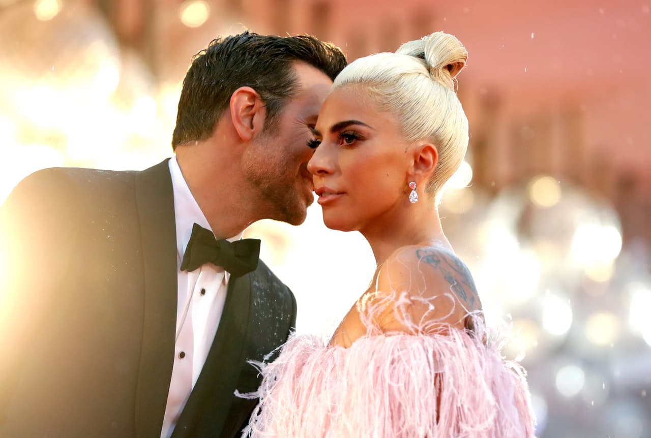Actress and singer Lady Gaga, right, and actor Bradley Cooper pose for photographers upon arrival at the premiere of the film 'A Star Is Born' at the 75th edition of the Venice Film Festival in Venice, Italy, Friday, Aug. 31, 2018. (AP Photo/Kirsty Wigglesworth)