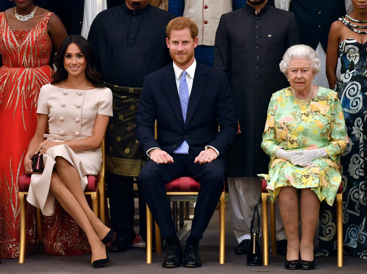 FILE - In this Tuesday, June 26, 2018 file photo, Britain's Queen Elizabeth, Prince Harry and Meghan, Duchess of Sussex pose for a group photo at the Queen's Young Leaders Awards Ceremony at Buckingham Palace in London. Sunday, May 19, 2019 marks the first wedding anniversary of the besotted couple. (John Stillwell/Pool Photo via AP, File)