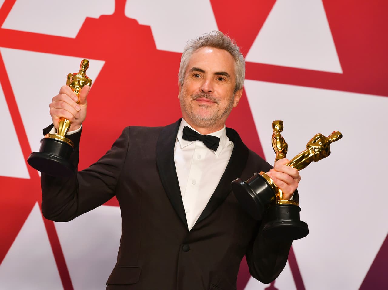 Alfonso Cuaron poses with the awards for best director for "Roma", best foreign language film for "Roma", and best cinematography for "Roma" in the press room at the Oscars on Sunday, Feb. 24, 2019, at the Dolby Theatre in Los Angeles. (Photo by Jordan Strauss/Invision/AP)