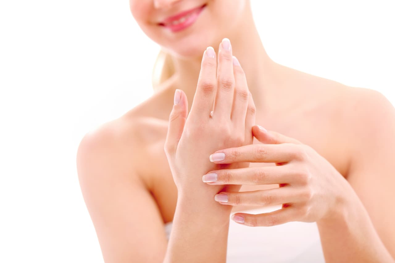 Beautiful woman caring her hands - selective focus