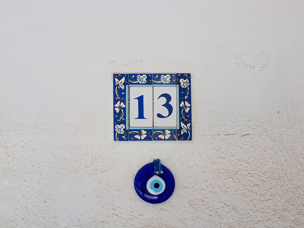 ceramic tile number thirteen and a blue good luck charm