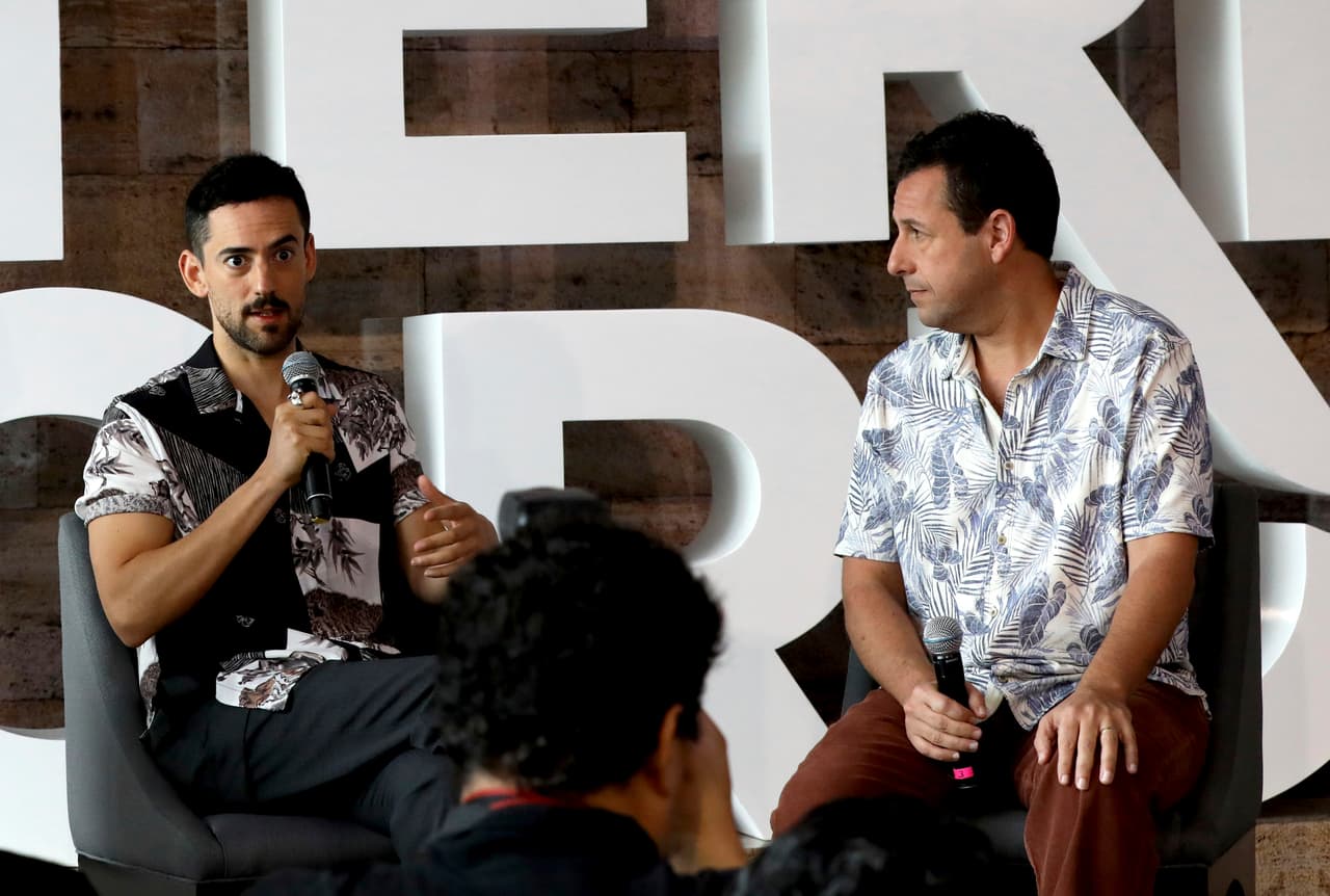 Actors Luis Gerardo Méndez, left, and Adam Sandler, right, respond to questions during a press conference for the Netflix film 'Murder Mystery' in Mexico City, Thursday, June 13, 2019. (AP Photo/Cristina Baussan)