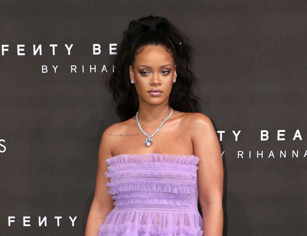FILE - In this Sept. 19, 2017 file photo, singer Rihanna poses for photographers at the Fenty Beauty by Rihanna fashion range launch during London Fashion Week. An ad on Snapchat asking users if they’d rather “Slap Rihanna” or “Punch Chris Brown” has spawned widespread outrage, including from the singer herself. Rihanna, who Brown was convicted of assaulting when she was his girlfriend in 2009, posted a statement on her Snapchat and Instagram accounts saying the ad intentionally brings shame to domestic violence victims. (Photo by Vianney Le Caer/Invision/AP, File)