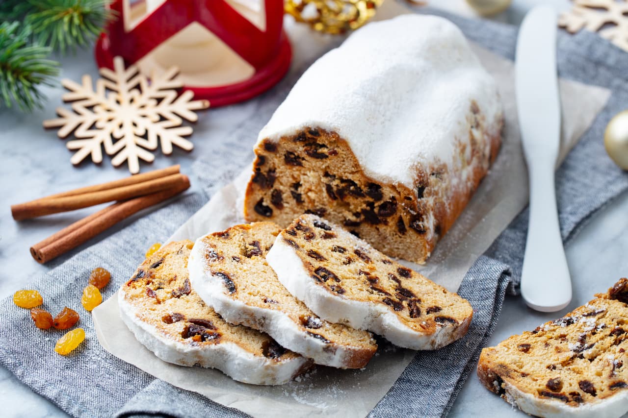 Christmas stollen. Traditional German festive dessert. Marble background. Close up.