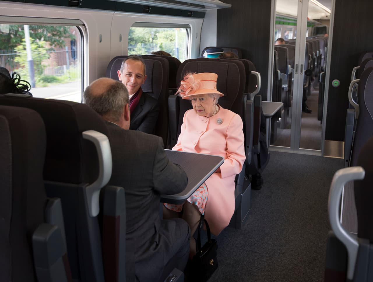 LONDON, ENGLAND - JUNE 13: Queen Elizabeth II sits next to Isambard Thomas, the great great great grandson of Isambard Kingdom Brunel, as she travels by train between Slough train station to Paddington Station to mark the 175th anniversary of the first train journey by a British Monarch on June 13, 2017 in London, United Kingdom. The first journey was made on the same route from Slough to Paddington by Queen Victoria on June 13th, 1842. (Photo by Paul Edwards - WPA Pool/Getty Images)