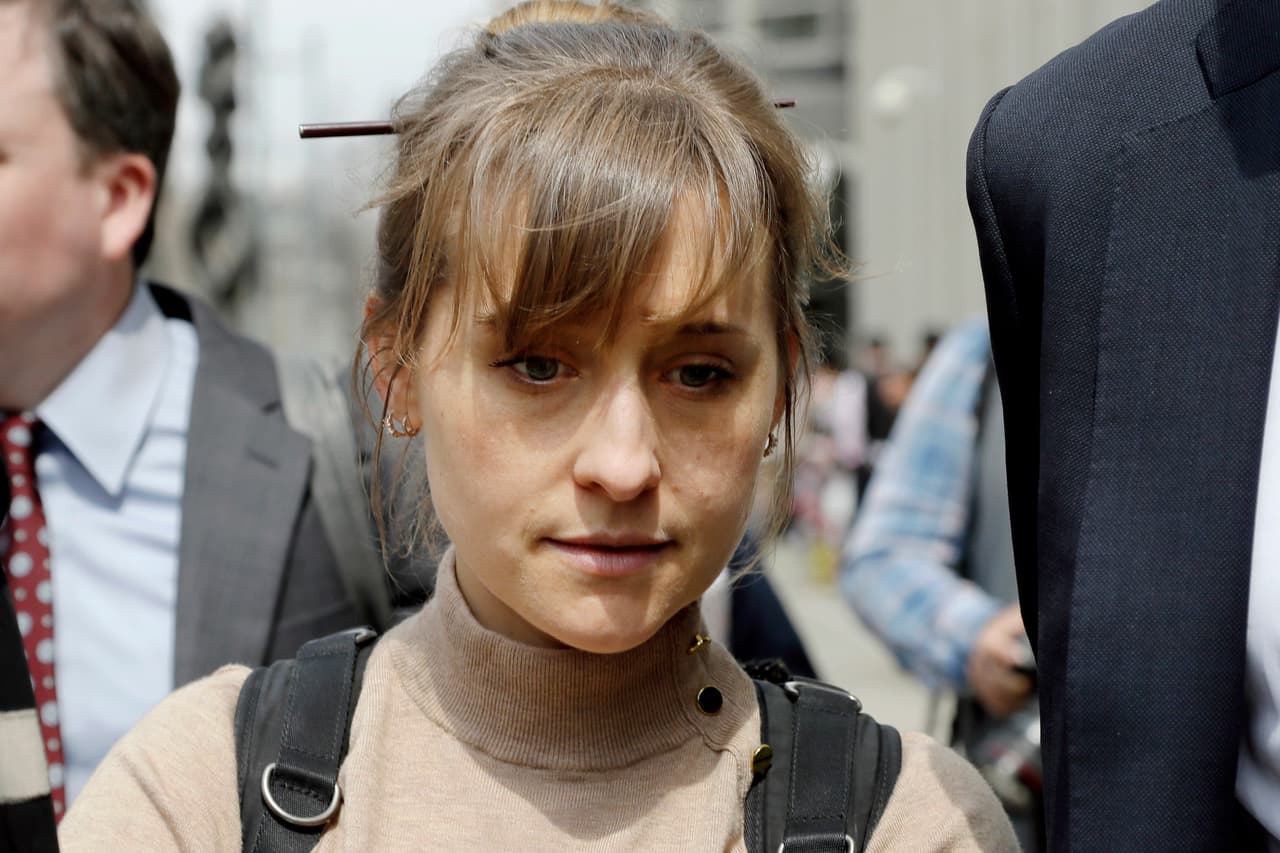 FILE- In this April 8, 2019 file photo, actress Allison Mack leaves Brooklyn federal court in New York after pleading guilty to racketeering charges in a case involving a cult-like group based in upstate New York called NXIVM. Some speculate that Mack may take the witness stand to testify against Keith Raniere, the group's one-time leader who is facing federal charges of forming a secret society within his organization that forced women to have sex with him. (AP Photo/Mark Lennihan, File)