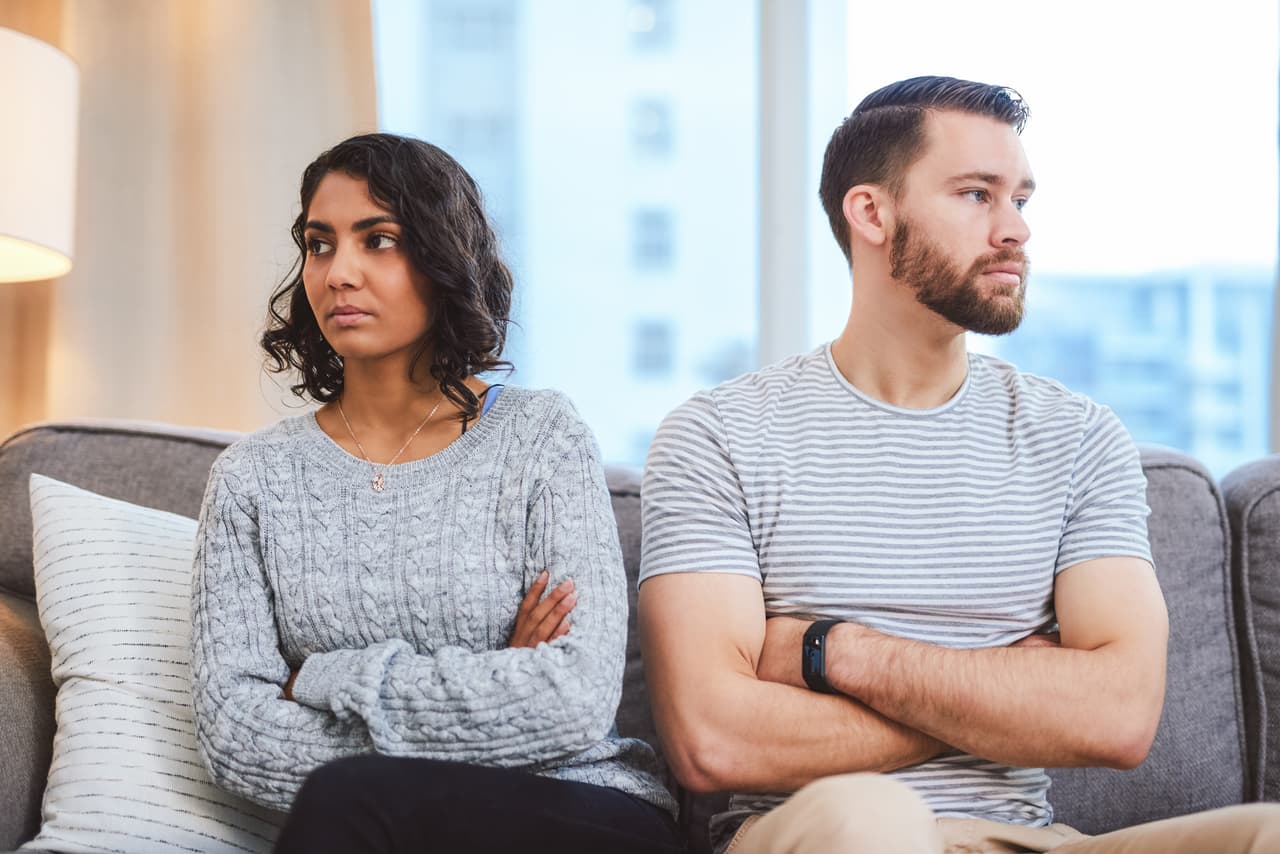 Cropped shot of a young couple giving each other the silent treatment during a fight at home