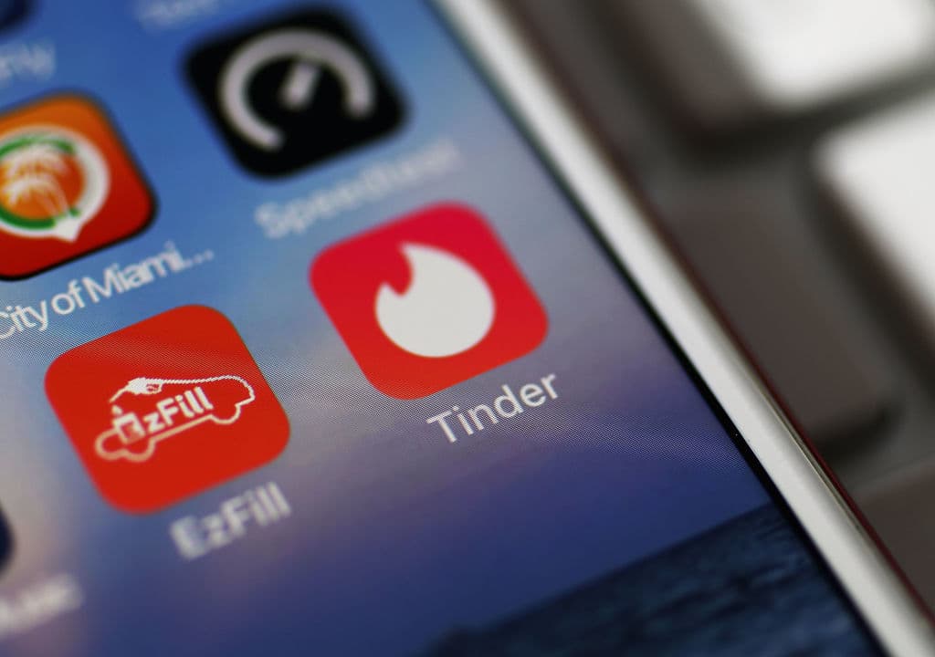 MIAMI, FL - AUGUST 14: In this photo illustration, the icon for the dating app Tinder is seen on the screen of an iPhone on August 14, 2018 in Miami, Florida. The co-founders of Tinder and eight other former and current executives of the dating app are suing the service's current owners for at least $2 billion. (Photo illustration by Joe Raedle/Getty Images)