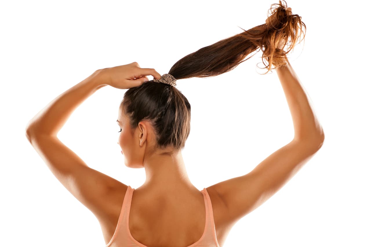 young woman tied her hair in a ponytail