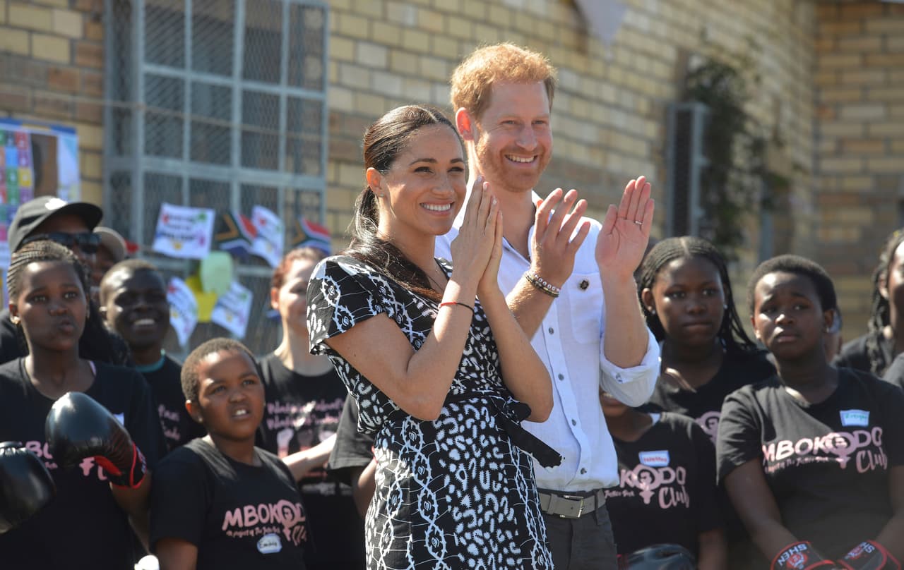 Britain's royal couple Prince Harry and Meghan Duchess of Sussex, greet youths on a visit to the Nyanga Methodist Church in Cape Town, South Africa, Monday, Sept, 23, 2019, which houses a project where children are taught about their rights, self-awareness and safety, and are provided self-defence classes and female empowerment training to young girls in the community. The royal couple are starting their first official tour as a family with their infant son, Archie (Courtney Africa / Africa News Agency via AP, Pool)