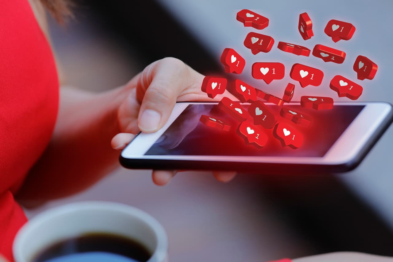 Women holding mobile phone with social media notification icon