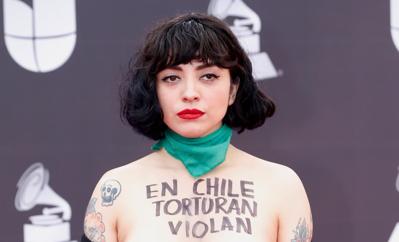 Mon Laferte arrives at the 20th Latin Grammy Awards with "En Chile torturan violan y matan" written on her body on Thursday, Nov. 14, 2019, at the MGM Grand Garden Arena in Las Vegas. (Photo by Eric Jamison/Invision/AP)