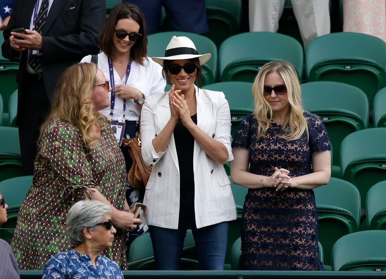 Meghan, Duchess of Sussex, center, on Court Number One applauds after United States' Serena Williams beat Slovenia's Kaja Juvan in a singles match during day four of the Wimbledon Tennis Championships in London, Thursday, July 4, 2019. (AP Photo/Tim Ireland)