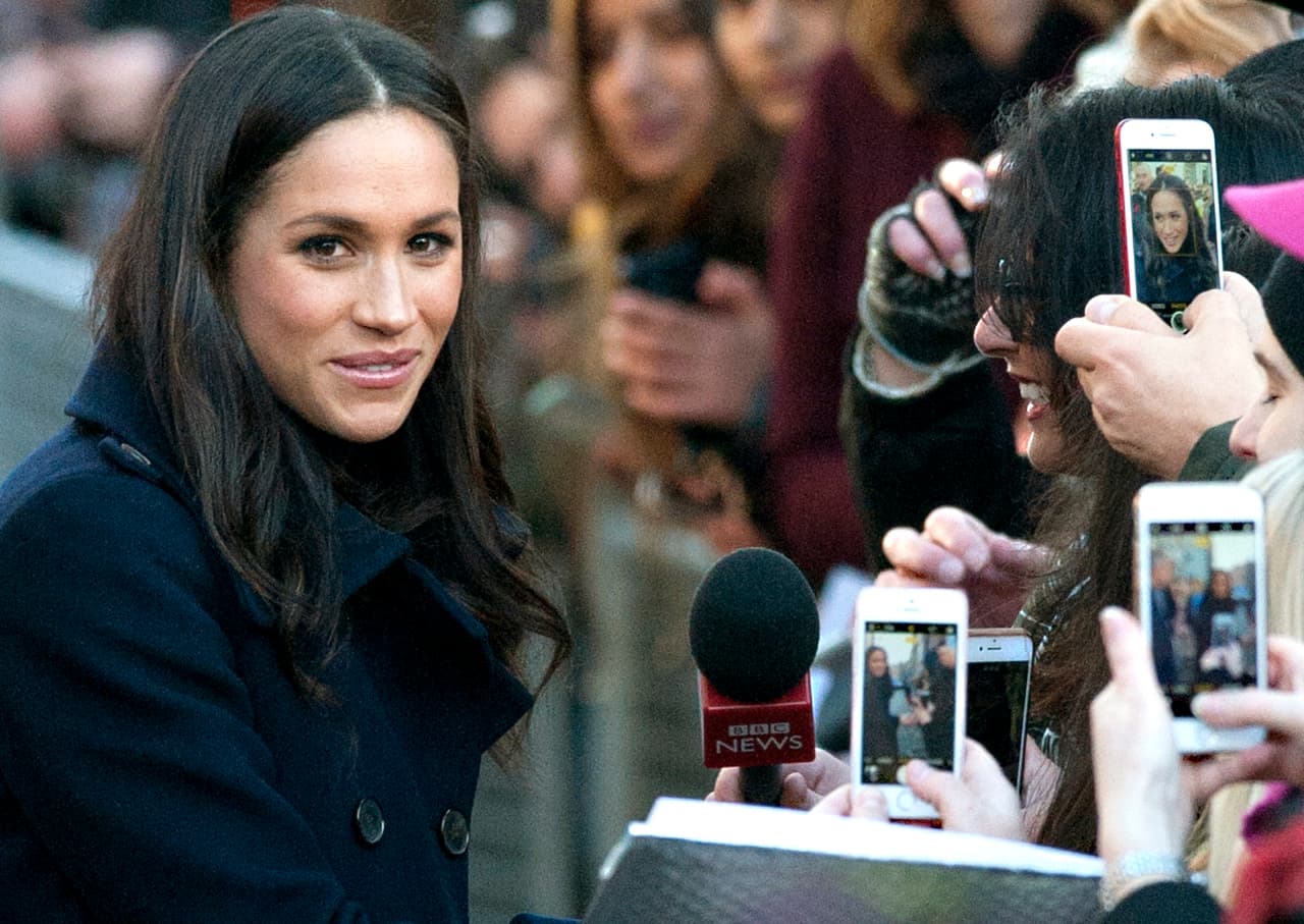 People take photos of Meghan Markle as she arrives with Britain's Prince Harry, at the Nottingham Contemporary to attend a Terrence Higgins Trust World AIDS Day charity fair, in Nottingham, England, Friday, Dec. 1, 2017. The couple took part in their first official visit together, choosing to raise awareness of HIV/AIDS with a visit to a youth project in Nottingham. (AP Photo/Rui Vieira)