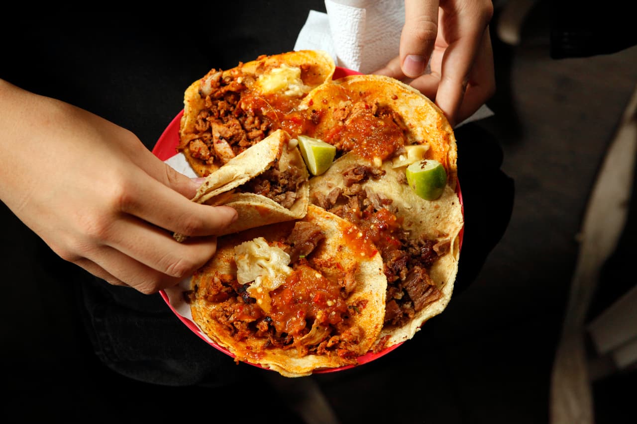 A woman holds a plate that include tacos al pastor and alambre at the inauguration of the Tlalpan Taco Fair featuring 20 different tacos, in Mexico City, Saturday, June 15, 2013. (AP Photo/Ivan Pierre Aguirre)(AP Photo/Ivan Pierre Aguirre)