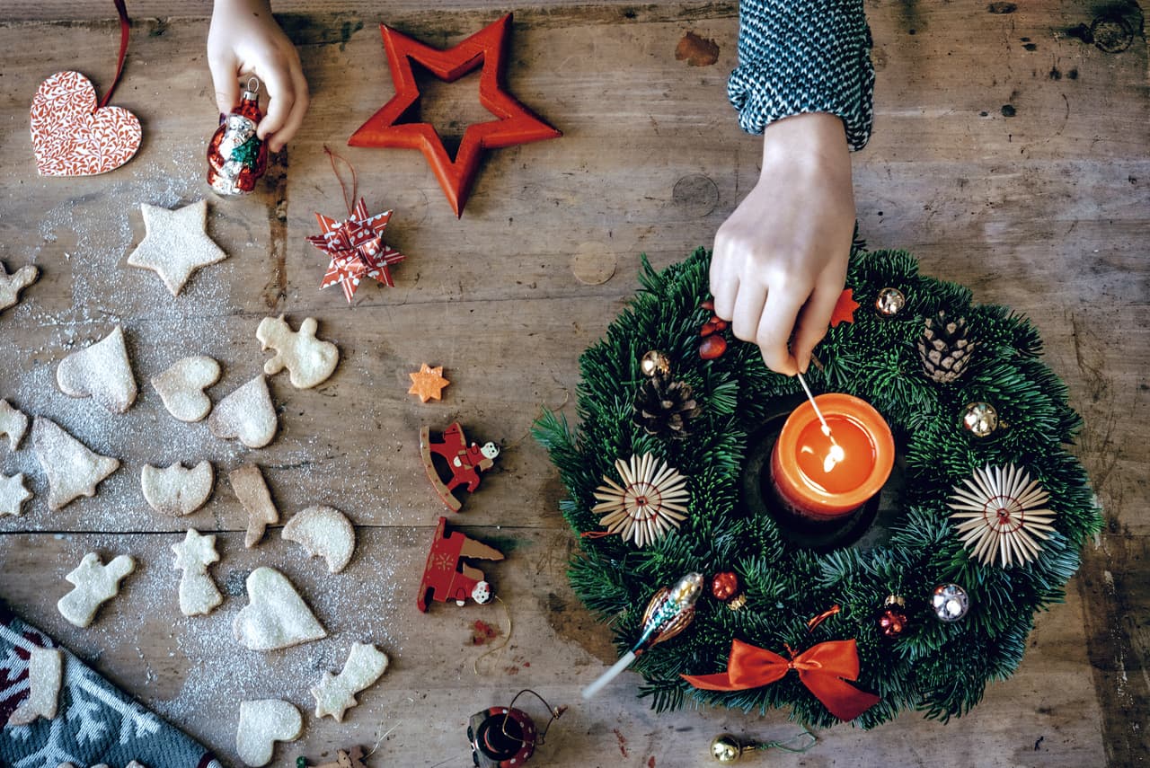 overhead view on christmas table with children hands and Advent wreath