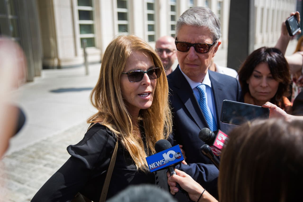 Actress Catherine Oxenberg, left, with Stanley Zareff and Toni Natalie, talks to the press following the arraignment of NXIVM leader Keith Raniere in federal court on Friday, April 13, 2018, in New York. Oxenberg's daughter India has been named as a co-conspirator in a criminal complaint against cult leader Keith Raniere. (AP Photo/Kevin Hagen)