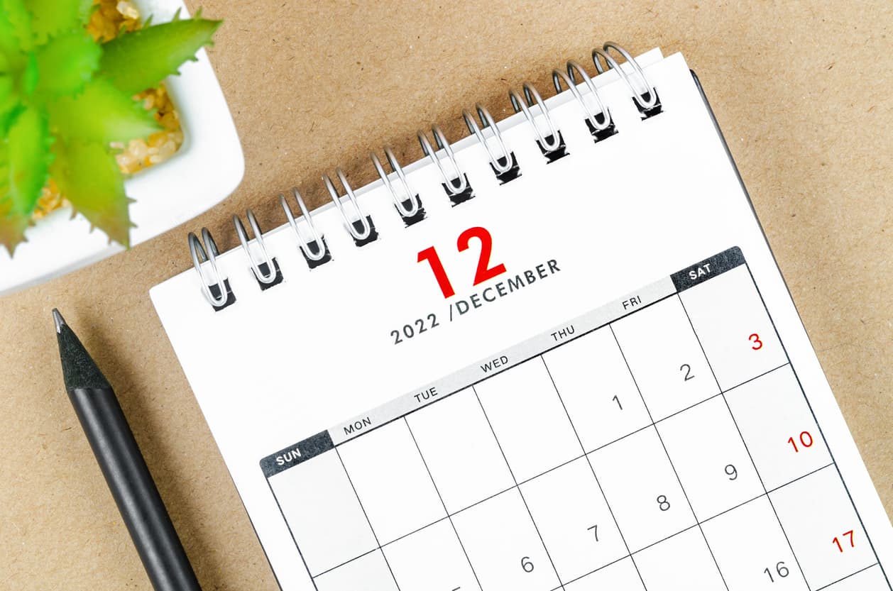 The December 2022 desk calendar on wooden table.