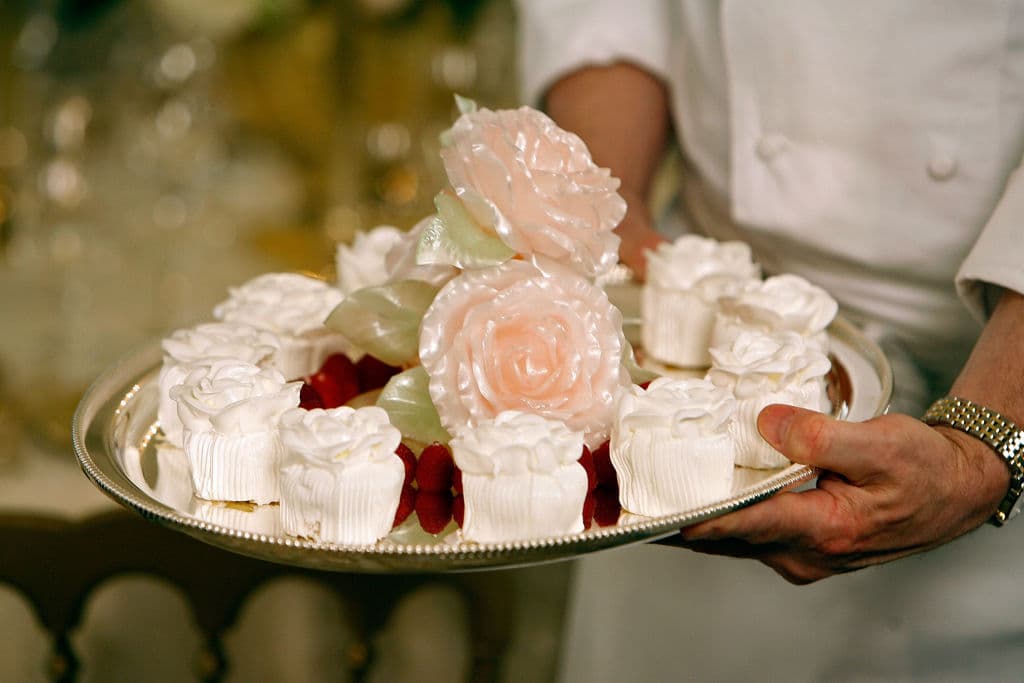 WASHINGTON - MAY 07: Sweet candy "rose blossoms" will be served for dessert during the dinner honoring Queen Elizabeth II in the State Dining room on the State Floor of the White House May 7, 2007 in Washington, DC. Thirteen tables will accommodate guests for the white-tie event. More than 300 white roses were used to build the decorative centerpieces. (Photo by Chip Somodevilla/Getty Images)