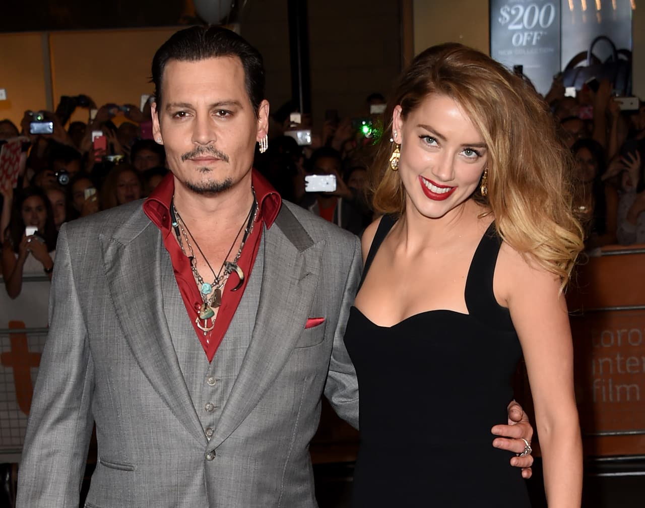 TORONTO, ON - SEPTEMBER 14: Actor Johnny Depp (L) and Actress Amber Heard attend the "Black Mass" premiere during the 2015 Toronto International Film Festival at The Elgin on September 14, 2015 in Toronto, Canada. (Photo by Jason Merritt/Getty Images)