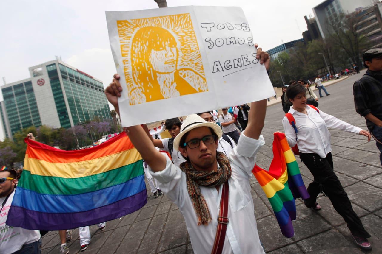 Members of a LGBT organization (lesbians, gays, bisexuals and transgenders) protest against the murder of transgender activist Agnes Torres Hernandez, at Paseo de la Reforma avenue in Mexico City March 18, 2012. The body of Torres Hernandez was found in the barranca de Xaxocuapatle of Atlixco and three suspects of the homicide were captured by the police, according to local media. The poster reads, "All we are Agnes". REUTERS/Edgard Garrido (MEXICO - Tags: CRIME LAW CIVIL UNREST POLITICS)