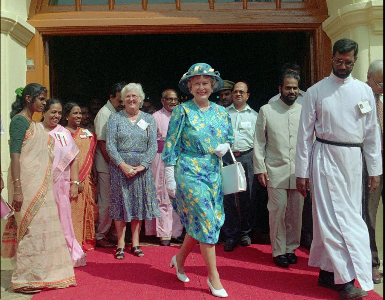 Britain's Queen Elizabeth II coming out of St. Francis Church, Cochin, Friday October 17, 1997. The building is the oldest European-built church in India. (AP PHOTO/Sherwin Castro)