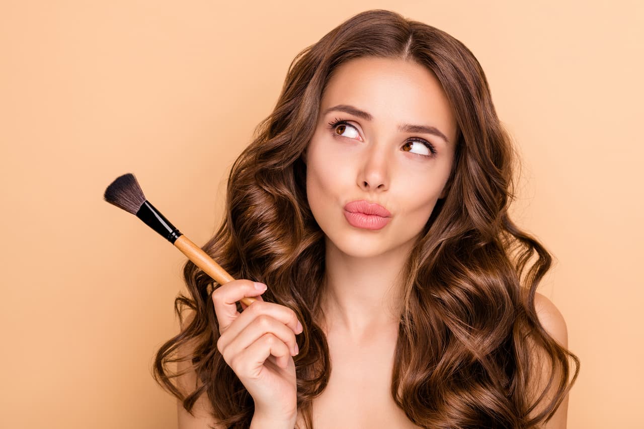 Close up photo of uncertain unsure girl hesitate hold blush blusher, dont know apply powder rouge to make visage ideal isolated over pastel color background