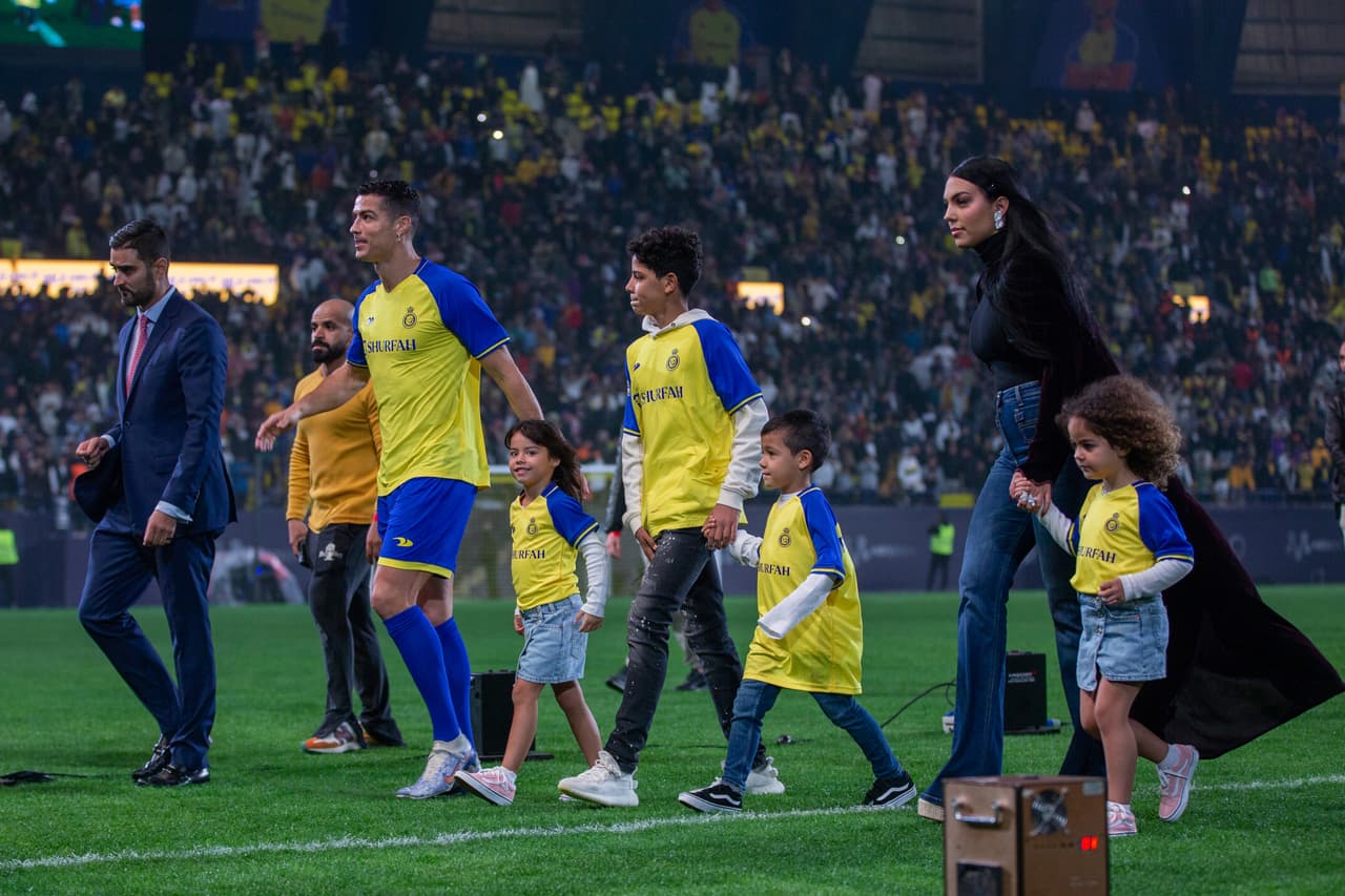RIYADH, SAUDI ARABIA - JANUARY 03: Cristiano Ronaldo accompanied by his partner Georgina Rodriguez and his son Cristiano Ronaldo Jr, greet the crowd during the official unveiling of Cristiano Ronaldo as an Al Nassr player at Mrsool Park Stadium on January 3, 2023 in Riyadh, Saudi Arabia. (Photo by Yasser Bakhsh/Getty Images)