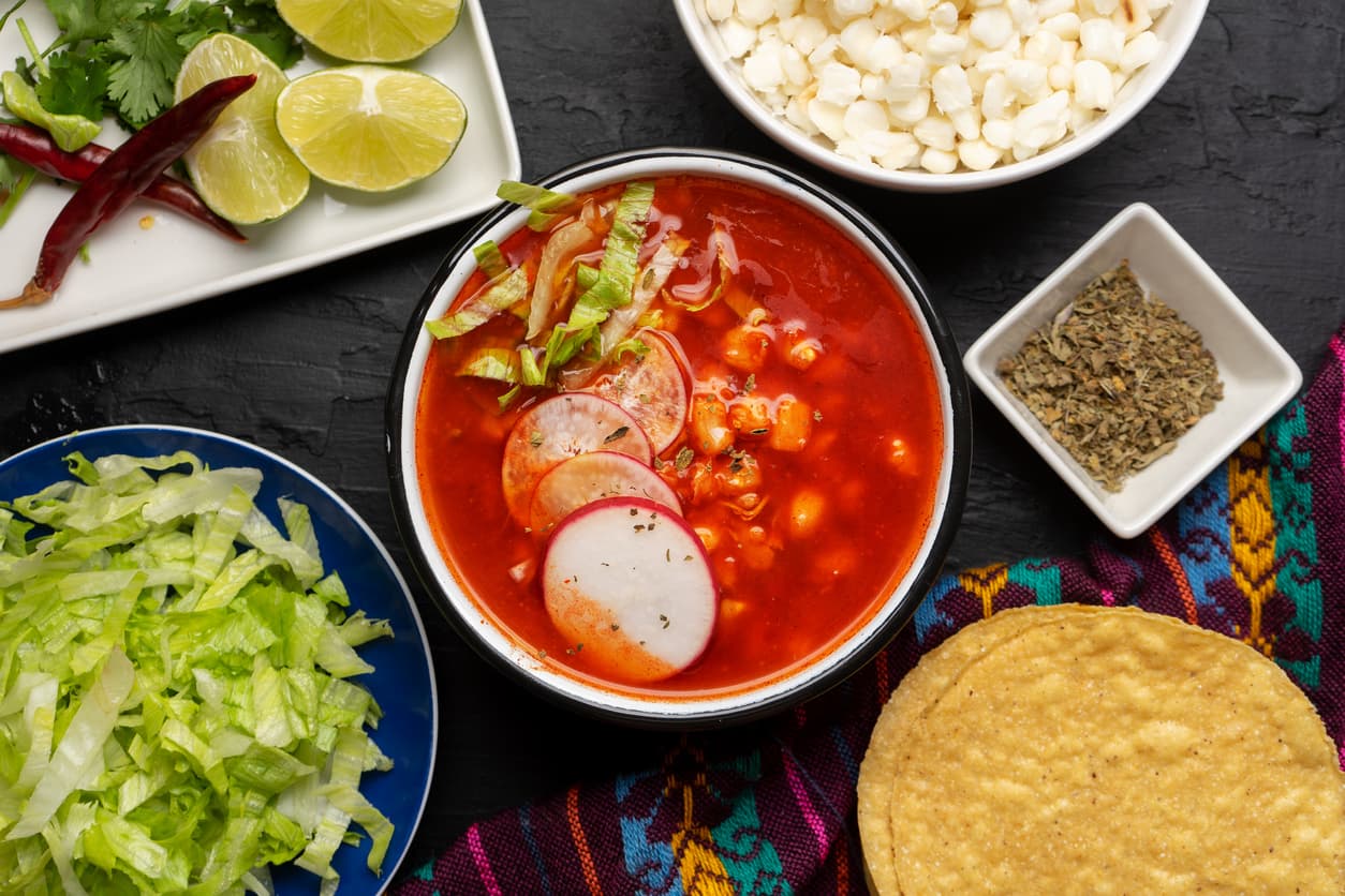 Traditional mexican food. Red pozole with chicken on dark background