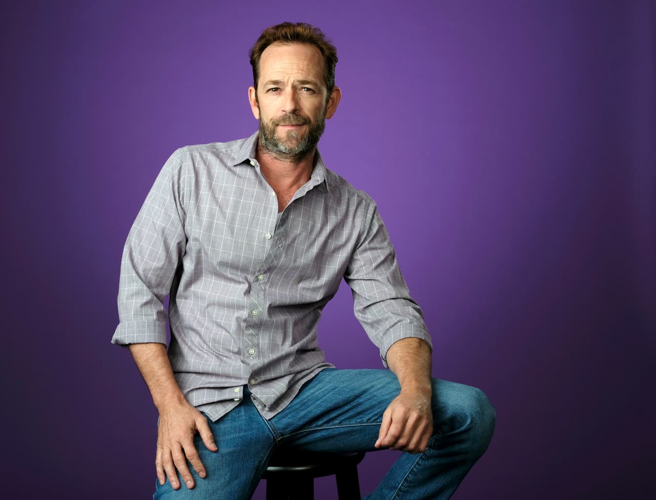 FILE - In this Aug. 6, 2018, file photo, Luke Perry, a cast member in the CW series "Riverdale," poses for a portrait during the 2018 Television Critics Association Summer Press Tour in Beverly Hills, Calif. A publicist for the "Riverdale" and "Beverly Hills, 90210" star says the actor has been hospitalized. Arnold Robinson said the 52-year-old actor is "currently under observation" at the hospital. (Photo by Chris Pizzello/Invision/AP, File)