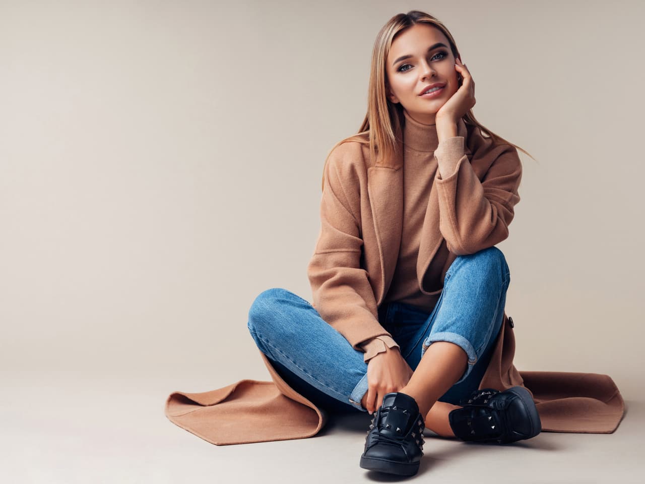 Smiling woman sitting on the floor