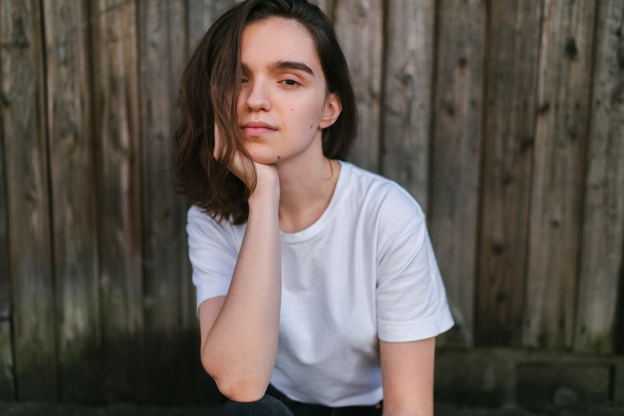 A portrait of a young and beautiful woman with no make up.