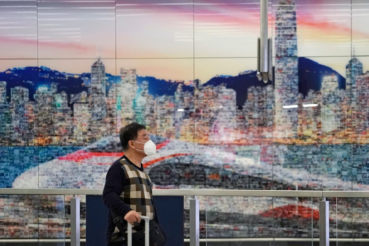 A passenger wears mask at the high speed train station, in Hong Kong, Wednesday, Jan. 22, 2020. Hong Kong's Department of Health on Wednesday confirmed its first case of the new strain of coronavirus, which has been spreading in China. (AP Photo/Kin Cheung)