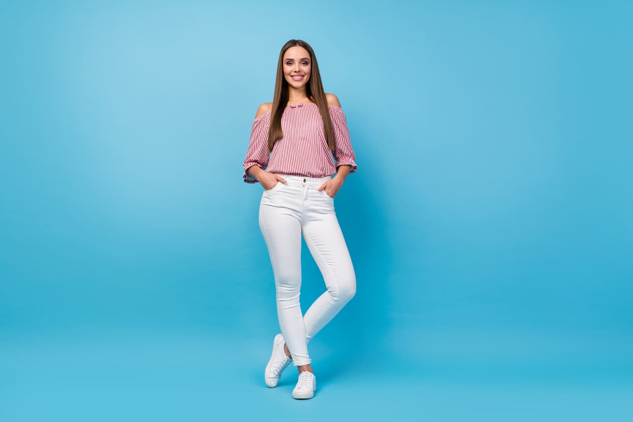 Full length body size view of lovely fashionable thin cheerful straight-haired girl posing isolated over vibrant blue color background.