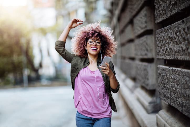 Young woman dancing in the city streets
