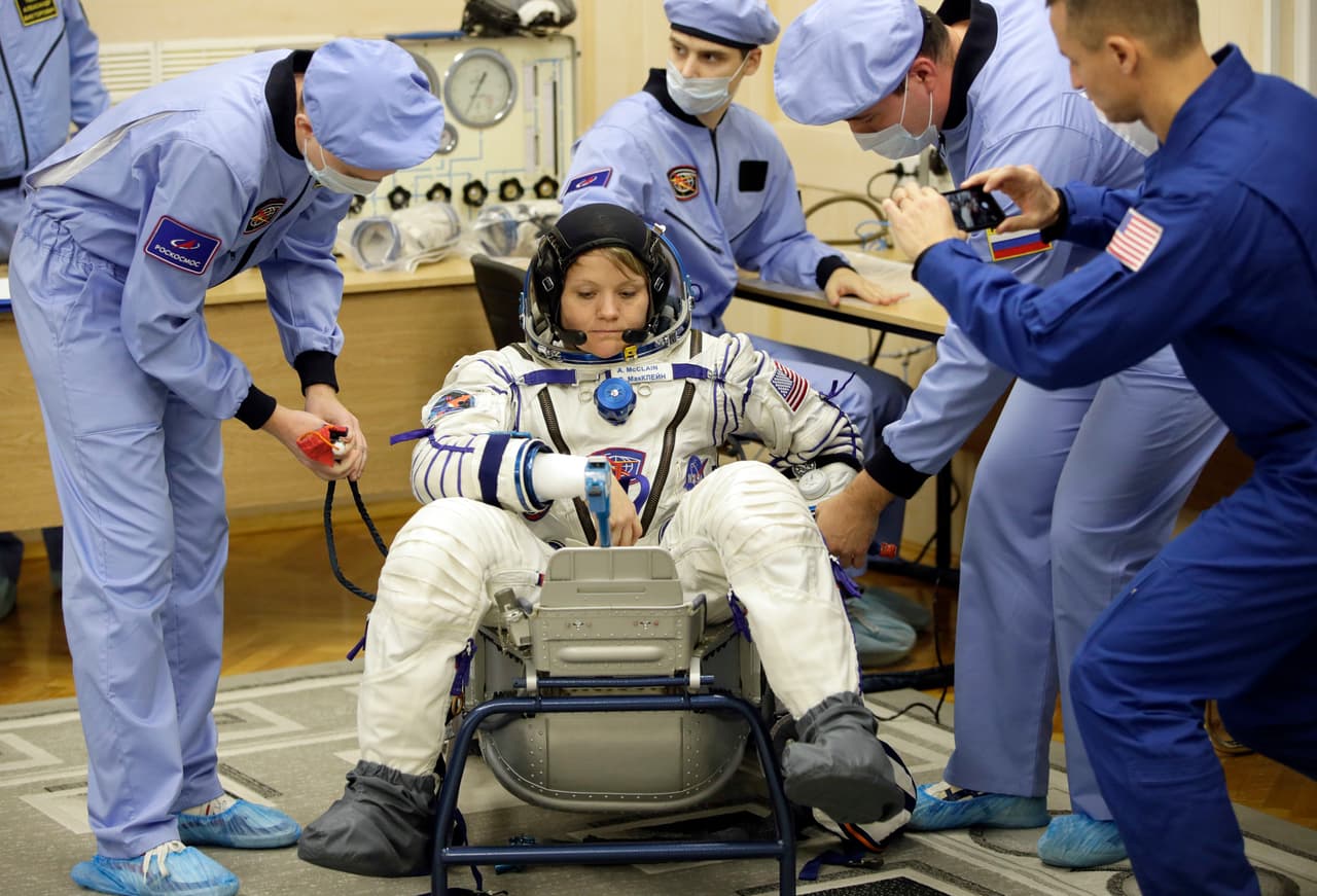 Russian Space Agency experts help U.S. astronaut Anne McClain, member of the main crew of the expedition to the International Space Station (ISS), during an inspection of her space suit prior to the launch of Soyuz MS-11 space ship at the Russian leased Baikonur cosmodrome, Kazakhstan, Monday, Dec. 3, 2018. (AP Photo/Dmitri Lovetsky)