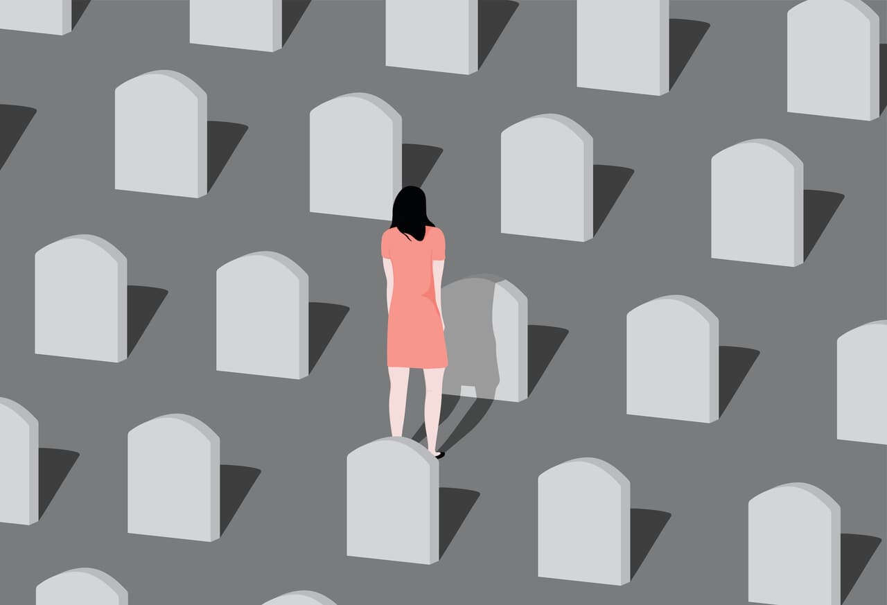Young woman visiting a loved one at the cemetery.