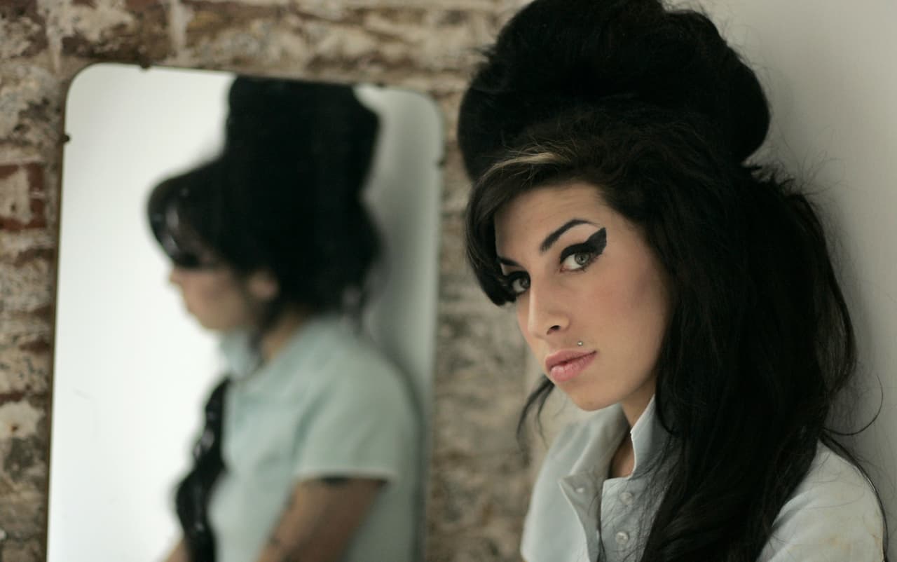 FILE - In this Feb. 16, 2007 file photo, British singer Amy Winehouse poses for photographs after being interviewed by The Associated Press at a studio in north London. Amy Winehouse, the beehived soul-jazz diva whose self-destructive habits overshadowed a distinctive musical talent, was found dead Saturday in her London home, police said. She was 27. (AP Photo/Matt Dunham, File)