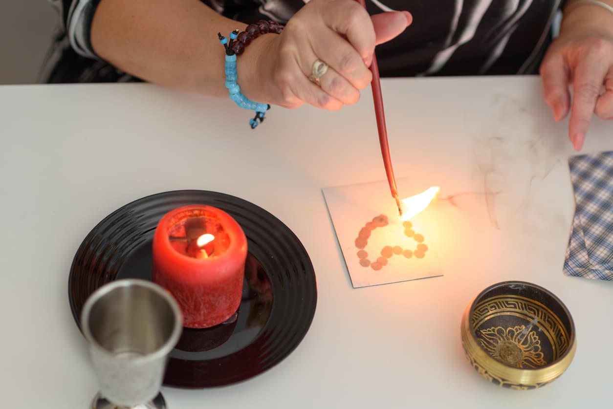 Fortune teller wonders on the candle, fortune teller make magic love spells. Mystical psychic, clairvoyance and divination.