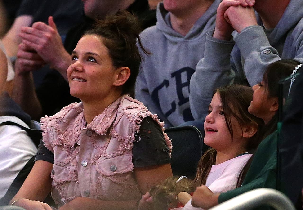 NEW YORK, NY - MARCH 30: Actress Katie Holmes and her daughter Suri Cruise attend the East Regional Final of the 2014 NCAA Men's Basketball Tournament between the Connecticut Huskies and the Michigan State Spartans at Madison Square Garden on March 30, 2014 in New York City. (Photo by Elsa/Getty Images)