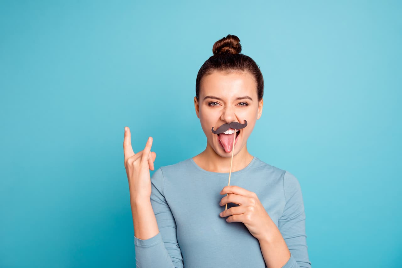 Portrait of charming beautiful careless teen teenager student excited have free time weekend holiday make faces wear stylish trendy pullover feel cool relaxed rest isolated scream on blue background.