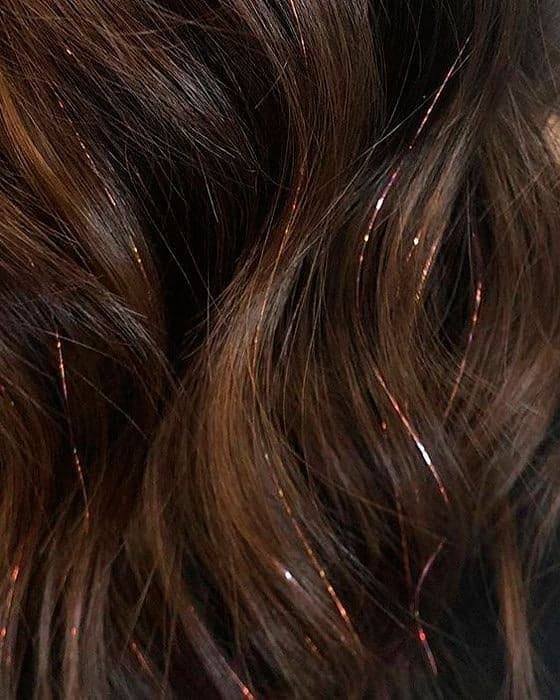 Las 
<i>twinkle extensions</i> son tiras de oropel que son aplicadas a lo largo de una cabellera con el fin de lograr destellos sutiles. Se colocan por medio de un método de nudo doble y teje dicha extensión desde la raíz del cabello, por lo que es un procedimiento libre de toda sustancia química o de láser.
<br>